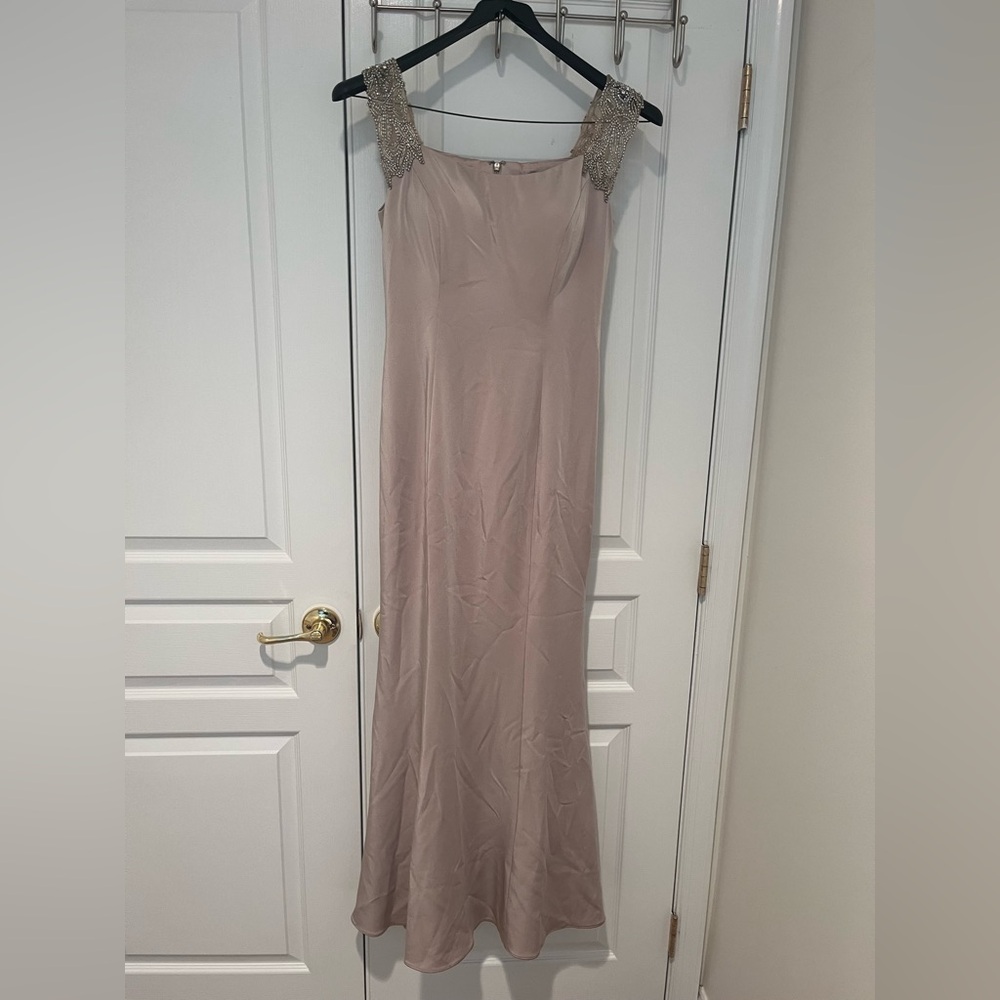 Cream tight fitting formal gown with beaded sleeves